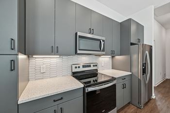 A modern kitchen with a stove, oven, microwave, and refrigerator.  at The Sophia, Venice, FL, 34275
